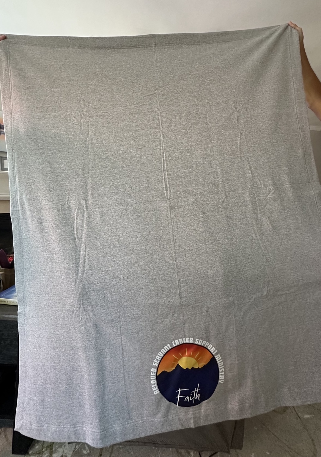 Gray Beloved Servant Cancer Support Ministry blanket with the Faith logo